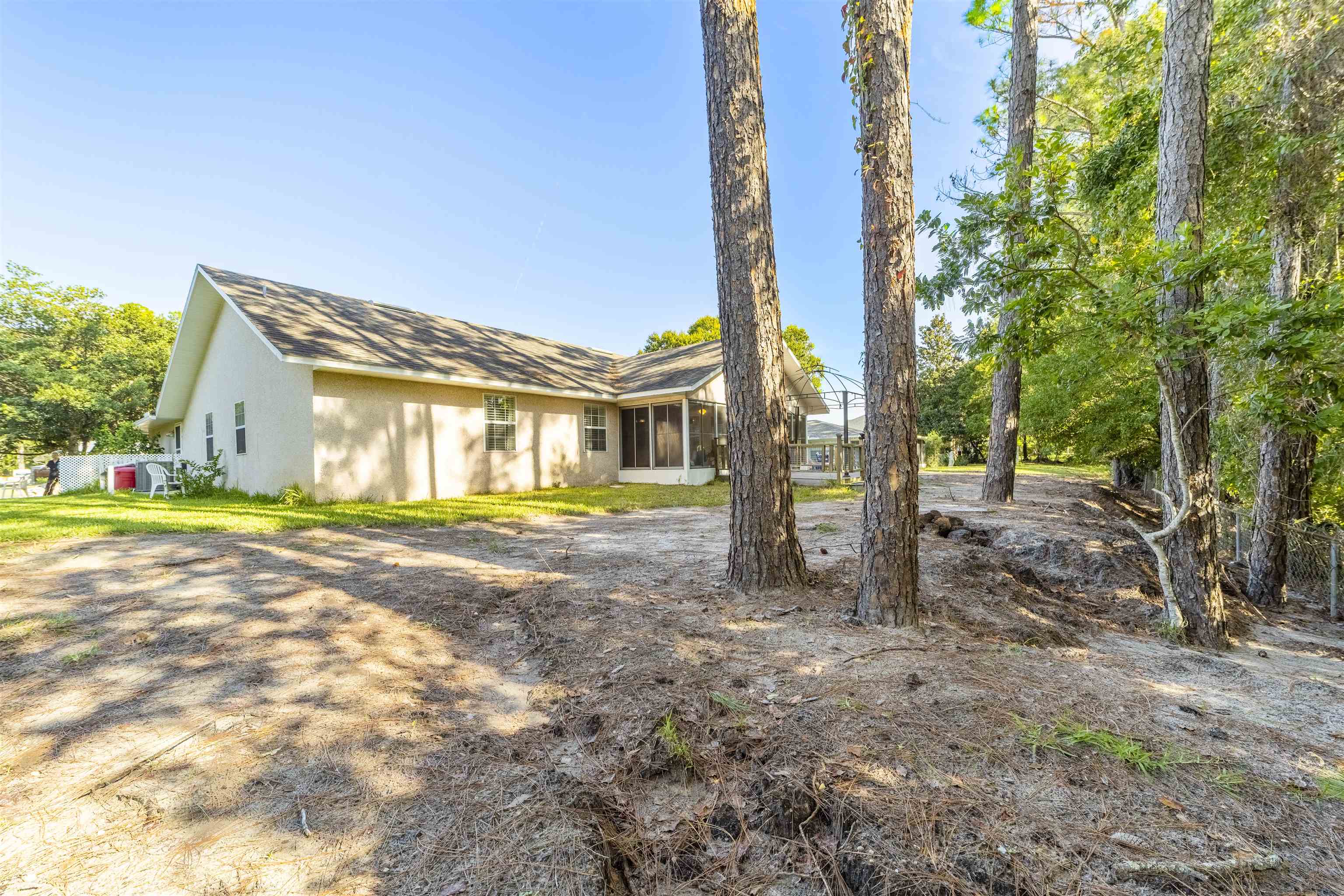 311 Graciela Circle St. Augustine, FL 32086 - Photo 61 of 65 Back of house featuring a sunroom and a shingled roof