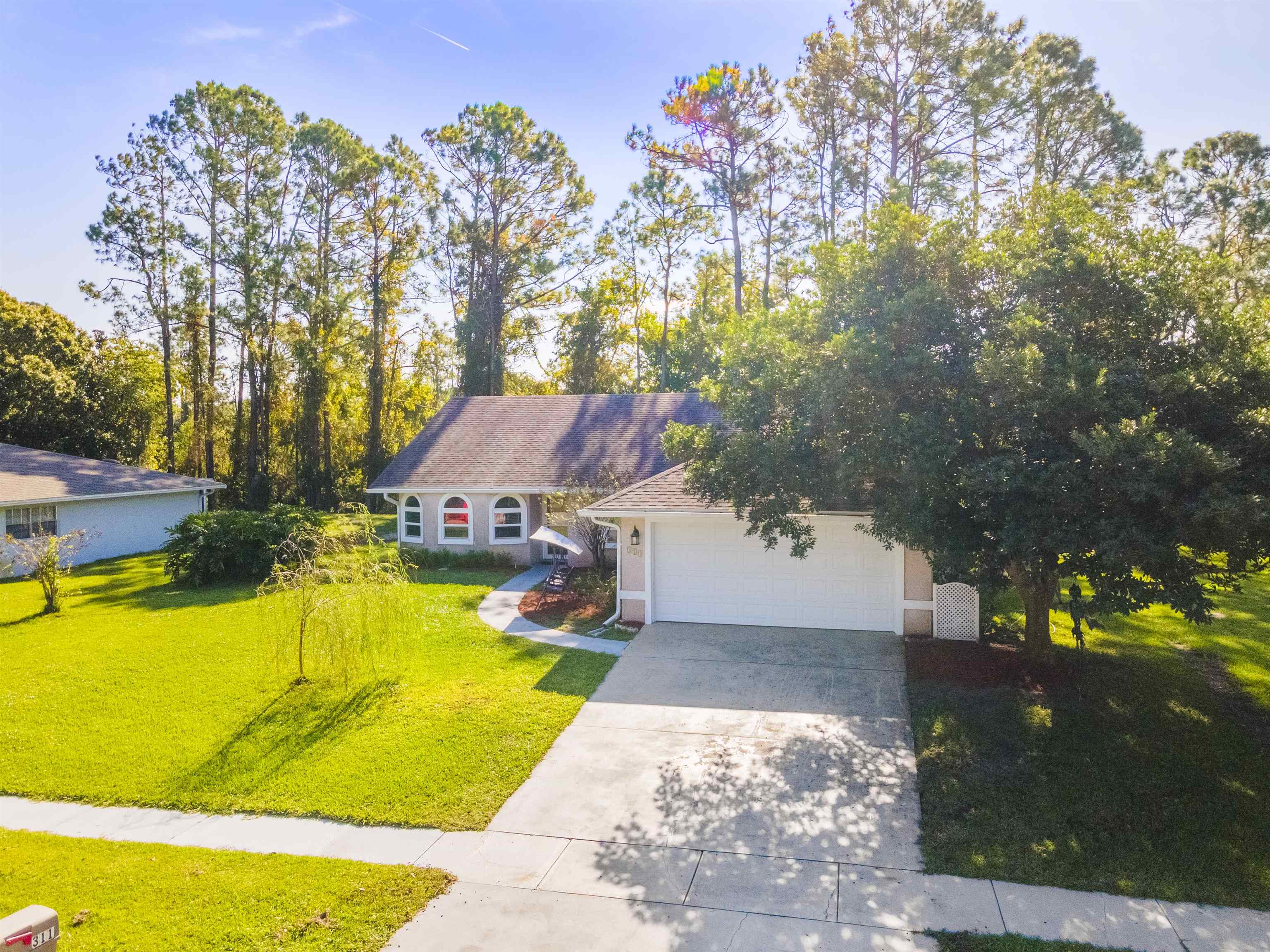 311 Graciela Circle St. Augustine, FL 32086 - Photo 65 of 65 View of front of house with a front lawn, concrete driveway, and a garage