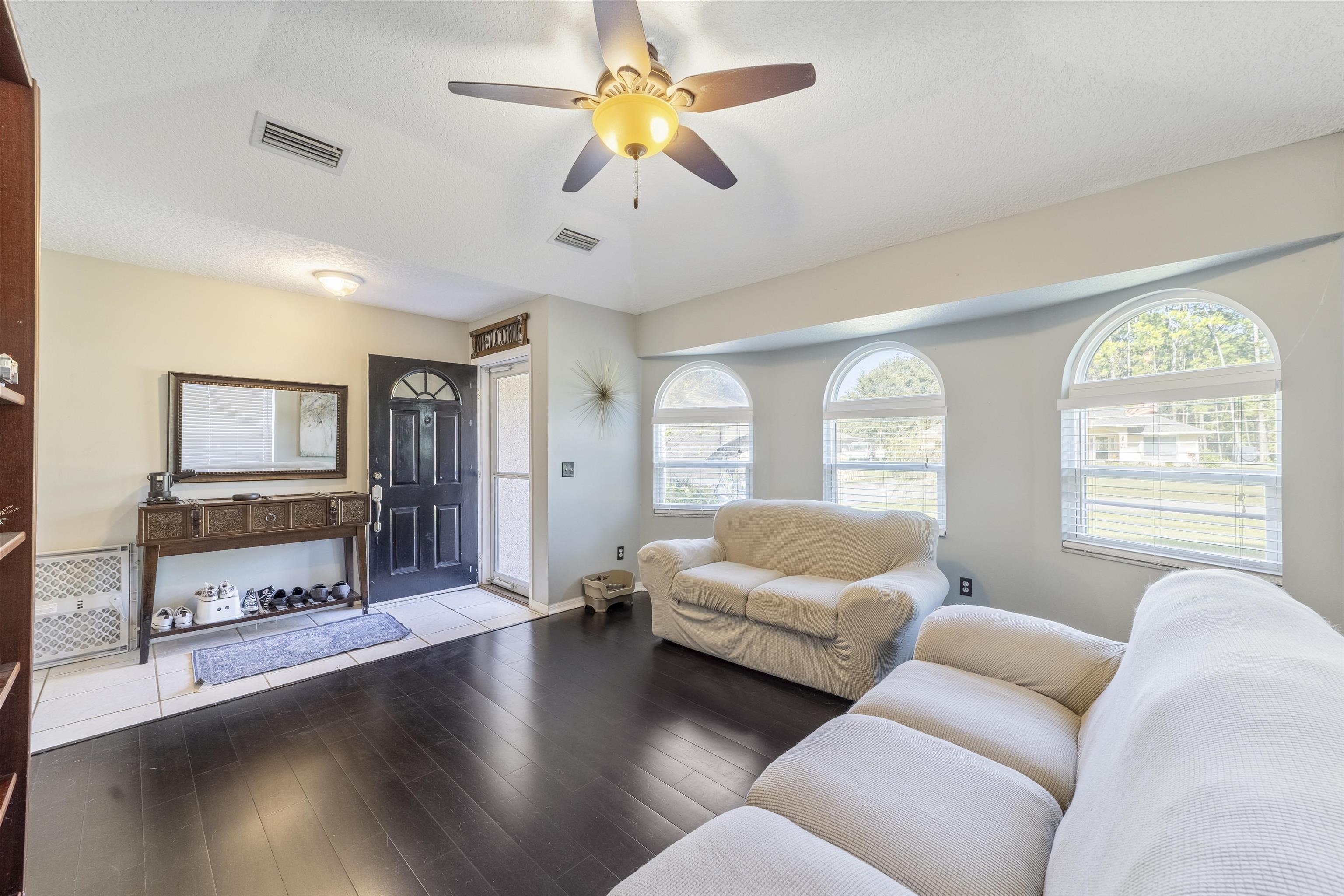 311 Graciela Circle St. Augustine, FL 32086 - Photo 7 of 65 Living room with a ceiling fan, wood finished floors, and a textured ceiling