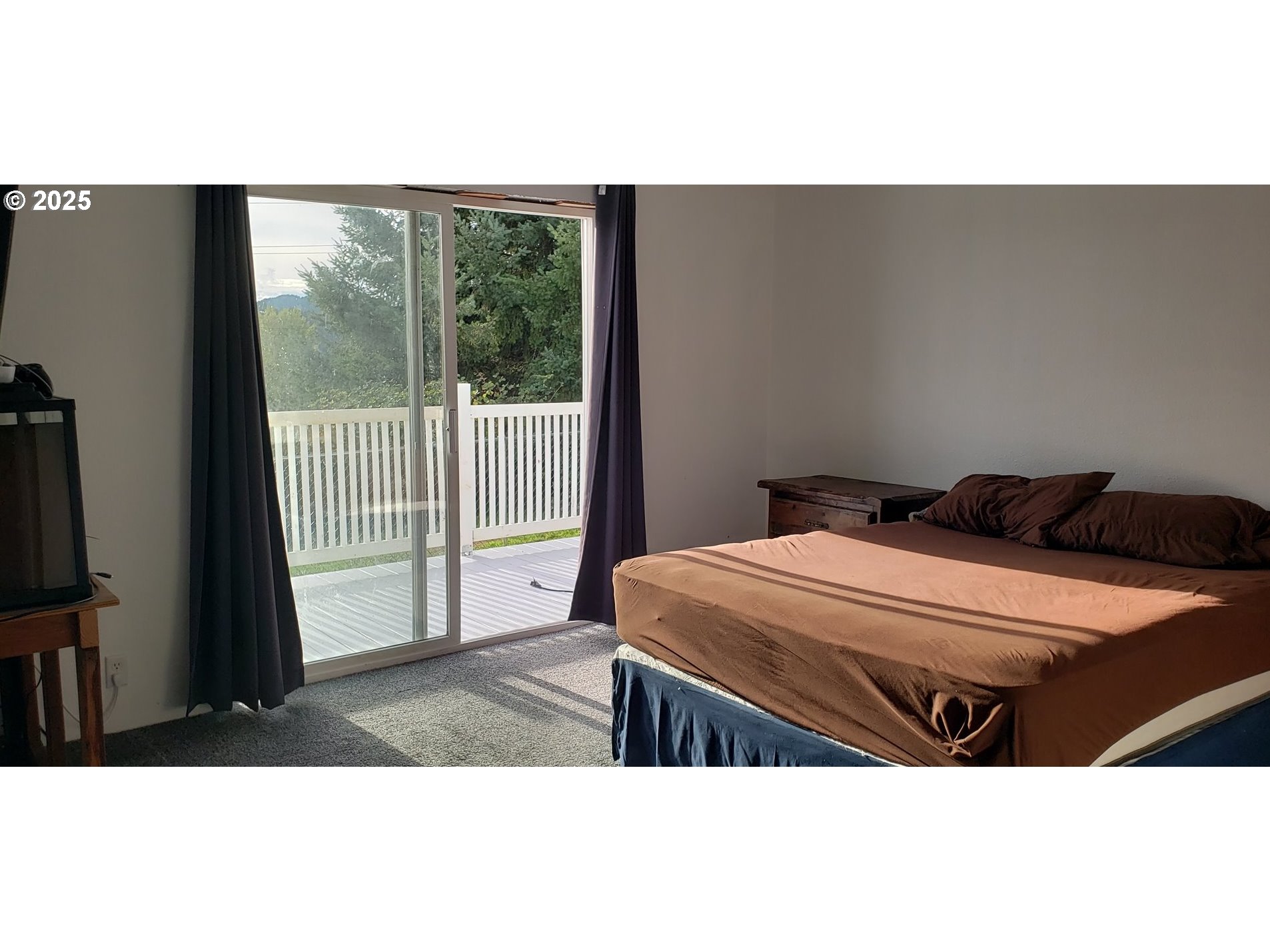 661 D Street Elkton, OR 97436 - Photo 12 of 28 a bedroom with a bed and a large window