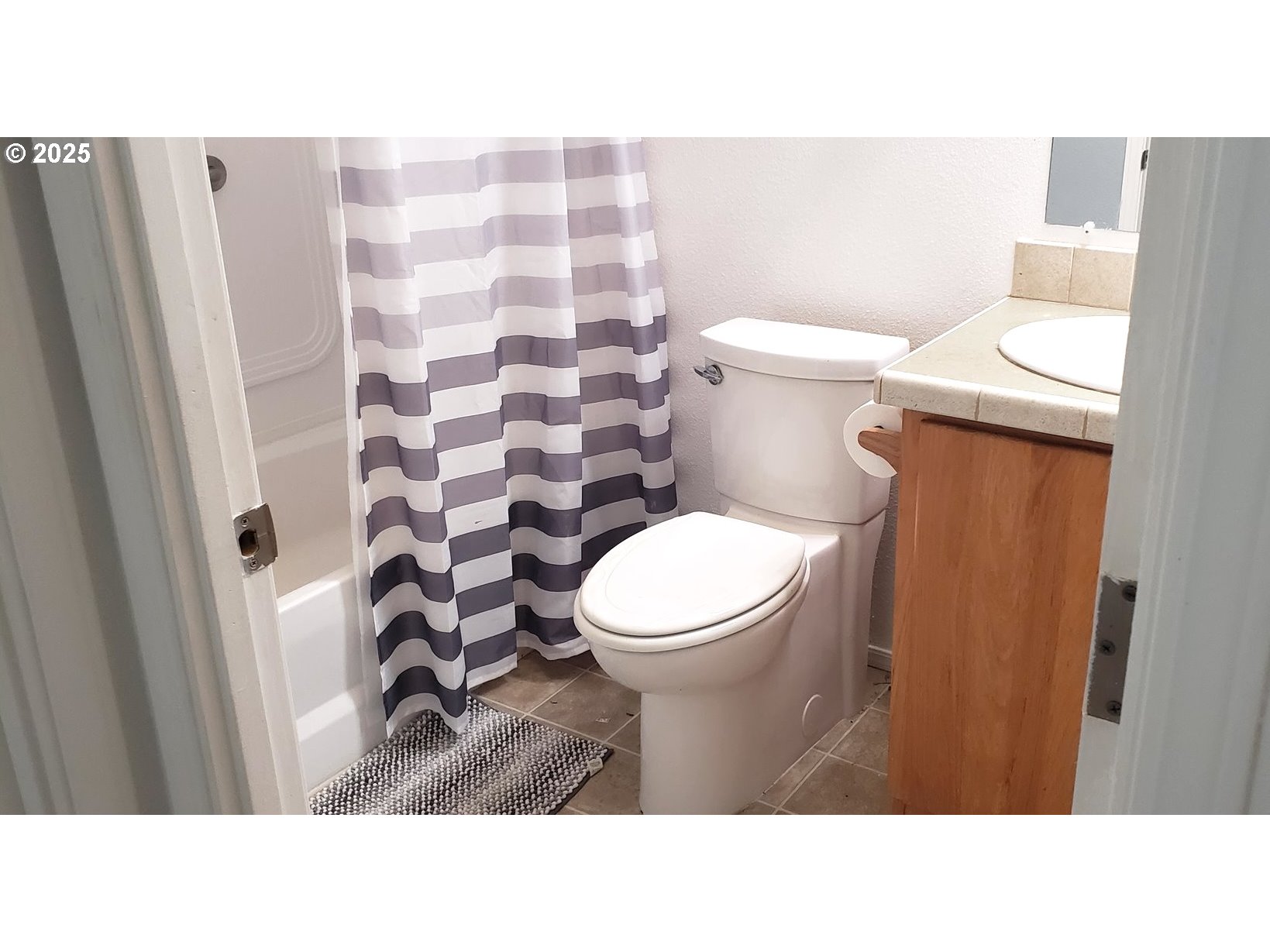 661 D Street Elkton, OR 97436 - Photo 17 of 28 a bathroom with a toilet and a shower curtain