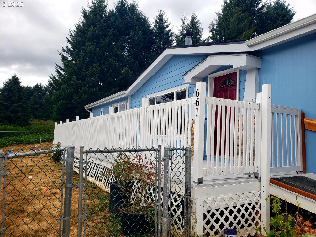 661 D Street Elkton, OR 97436 - Photo 2 of 28 a white house that has tree in front of it