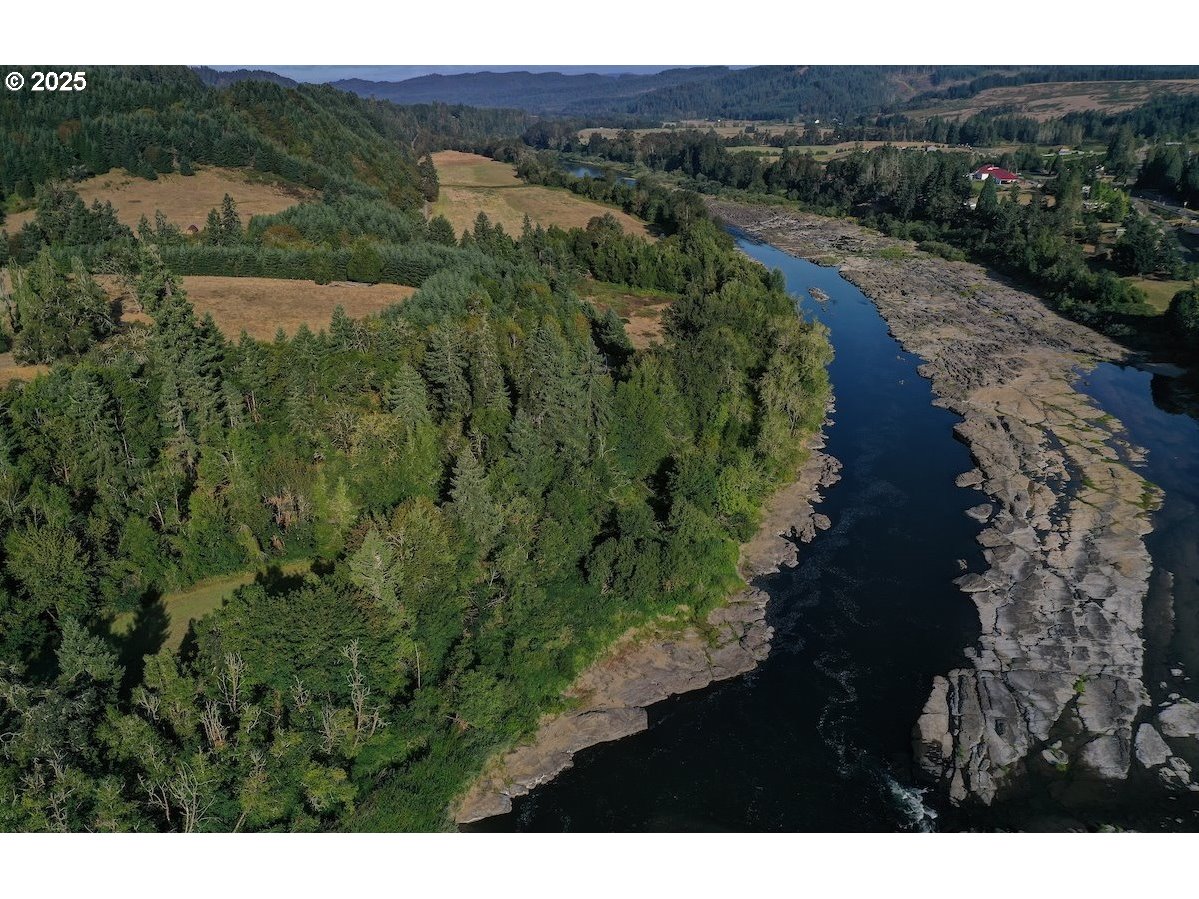 661 D Street Elkton, OR 97436 - Photo 27 of 28 a view of a lush green hillside and a houses