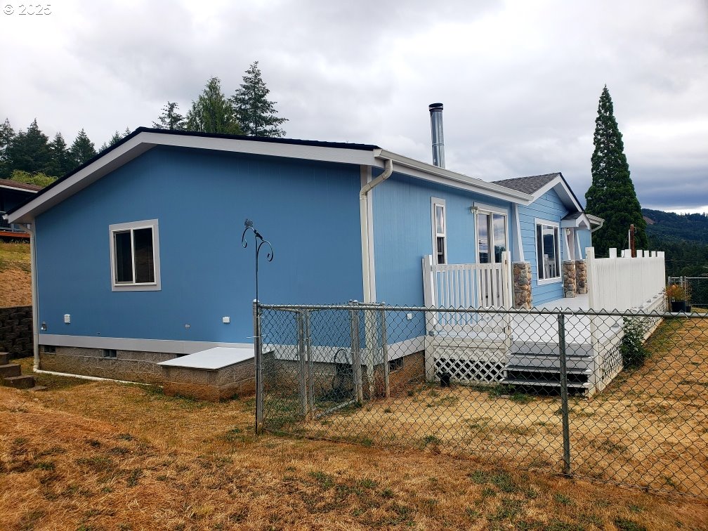 661 D Street Elkton, OR 97436 - Photo 4 of 28 a view of a house with a patio