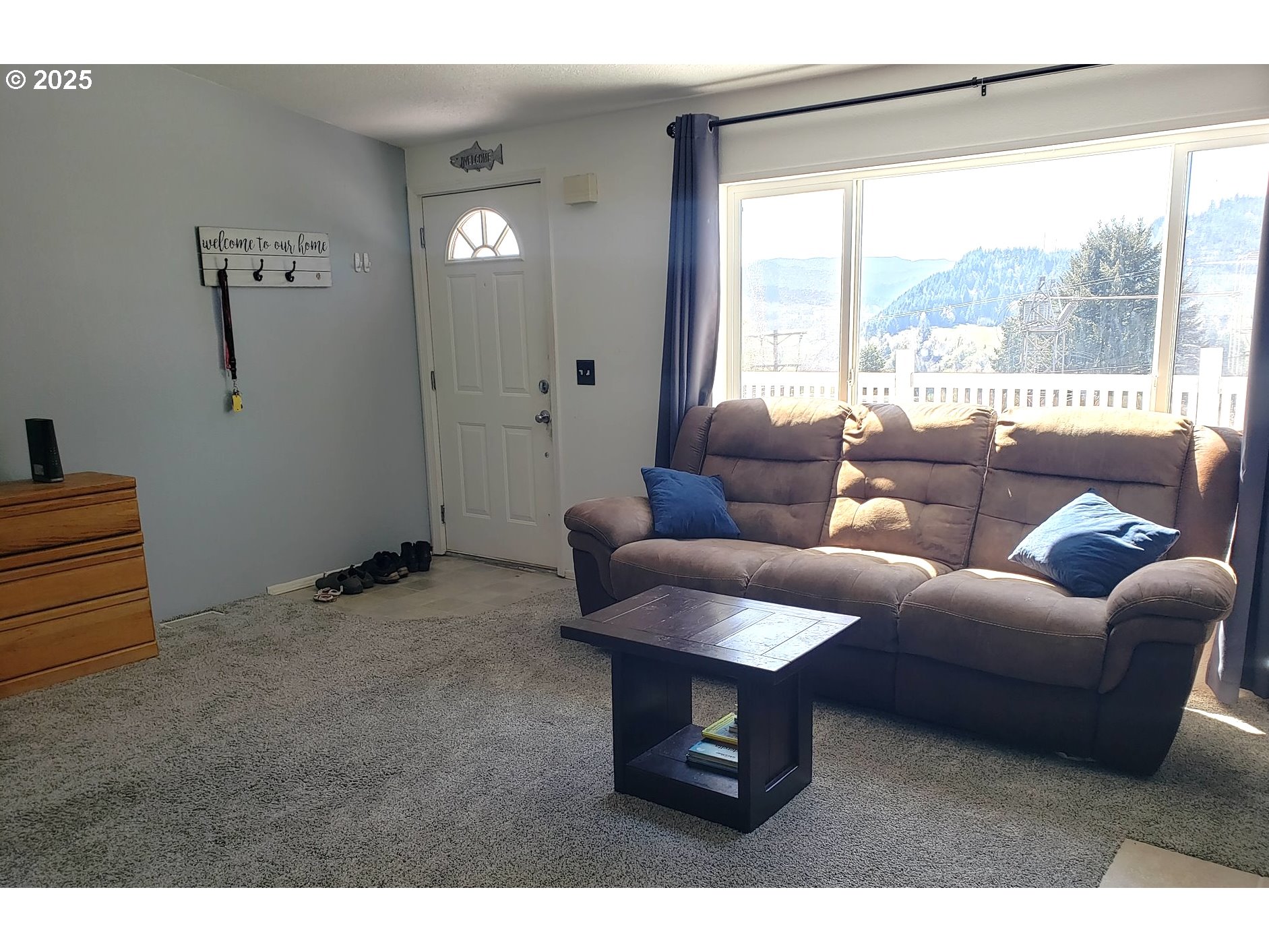 661 D Street Elkton, OR 97436 - Photo 6 of 28 a living room with furniture and a large window