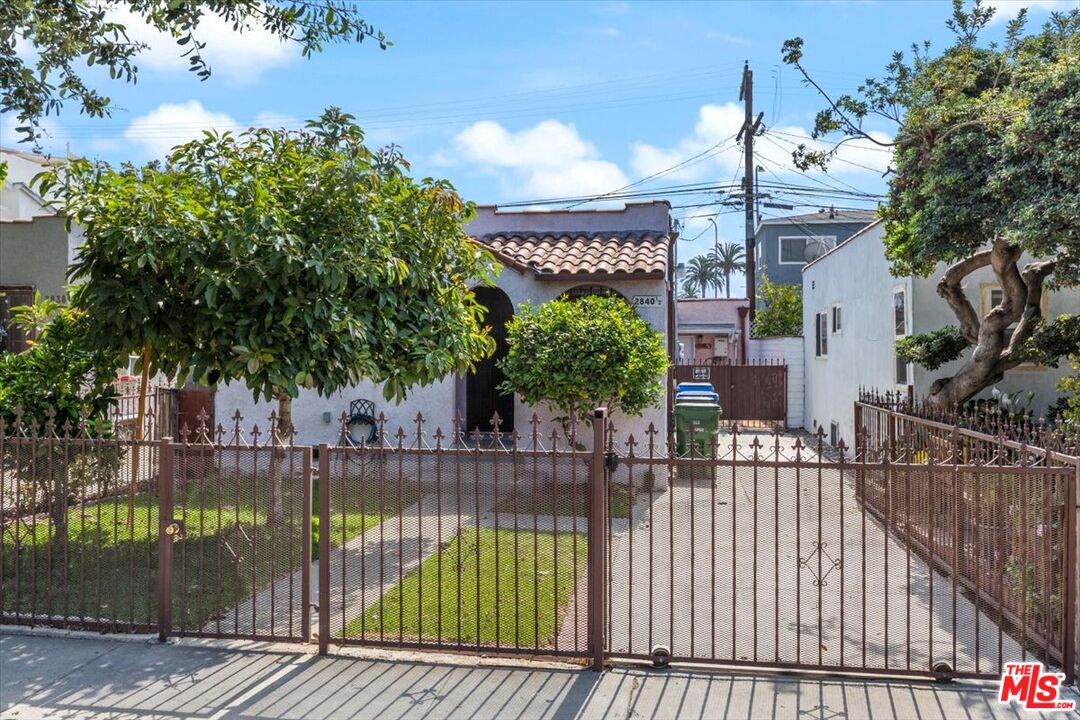 2840 South Mansfield Avenue Los Angeles, CA 90016 - Photo 2 of 50 swimming pool view with plants and large trees