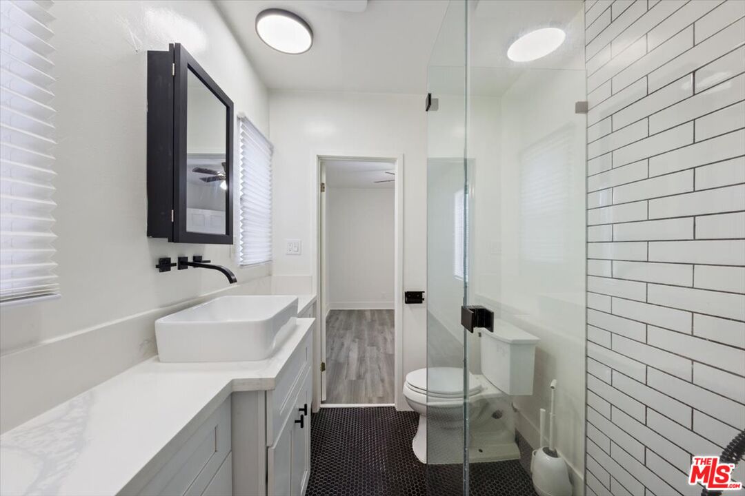 2840 South Mansfield Avenue Los Angeles, CA 90016 - Photo 22 of 50 a bathroom with a sink toilet and shower