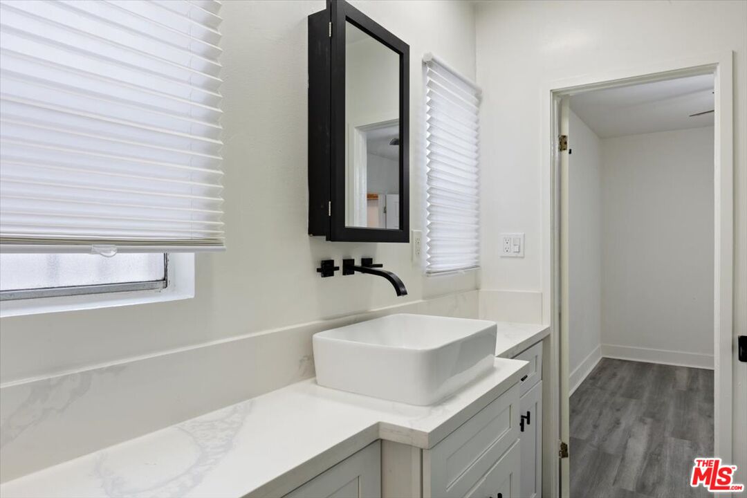 2840 South Mansfield Avenue Los Angeles, CA 90016 - Photo 23 of 50 a bathroom with a sink and a mirror