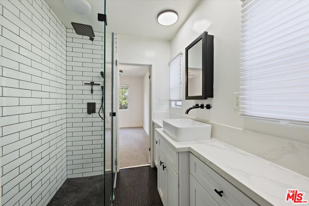 2840 South Mansfield Avenue Los Angeles, CA 90016 - Photo 24 of 50 a bathroom with a sink and a mirror