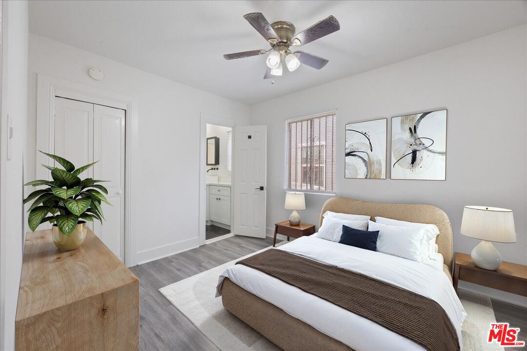 2840 South Mansfield Avenue Los Angeles, CA 90016 - Photo 25 of 50 a bedroom with a bed and a chandelier