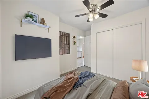 a bedroom with a bed and a flat screen tv