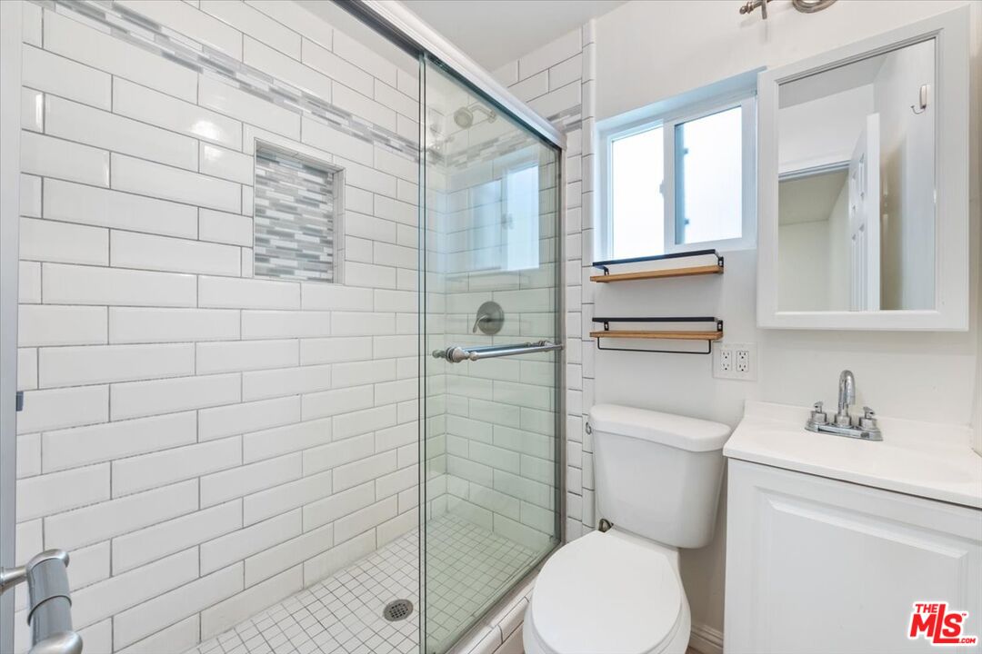 2840 South Mansfield Avenue Los Angeles, CA 90016 - Photo 44 of 50 a bathroom with a toilet and a shower