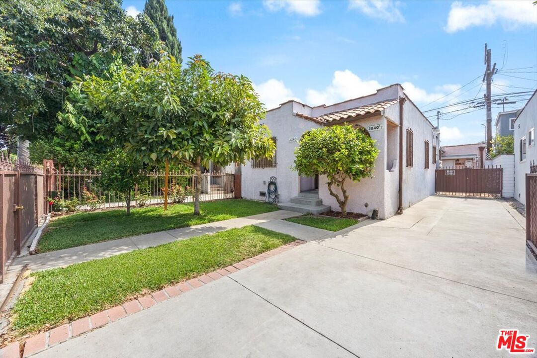 2840 South Mansfield Avenue Los Angeles, CA 90016 - Photo 45 of 50 a view of a house with a yard and a garden