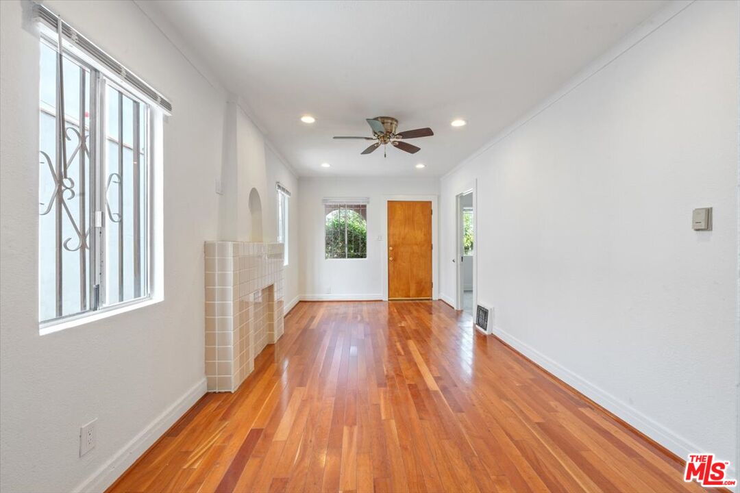 2840 South Mansfield Avenue Los Angeles, CA 90016 - Photo 9 of 50 a view of an empty room with a window and wooden floor