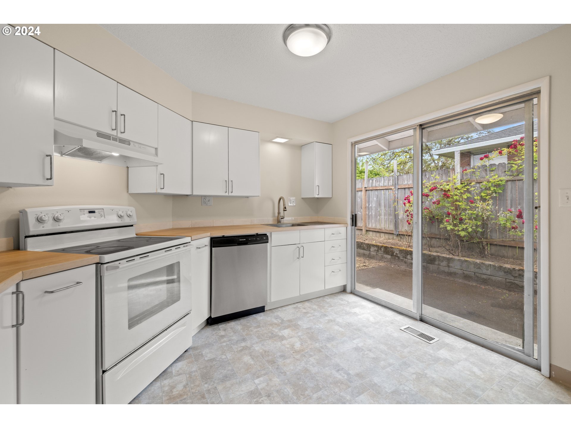 11700 Southwest Denney Road Beaverton, OR 97008 - Photo 14 of 23 a kitchen with white cabinets and white appliances