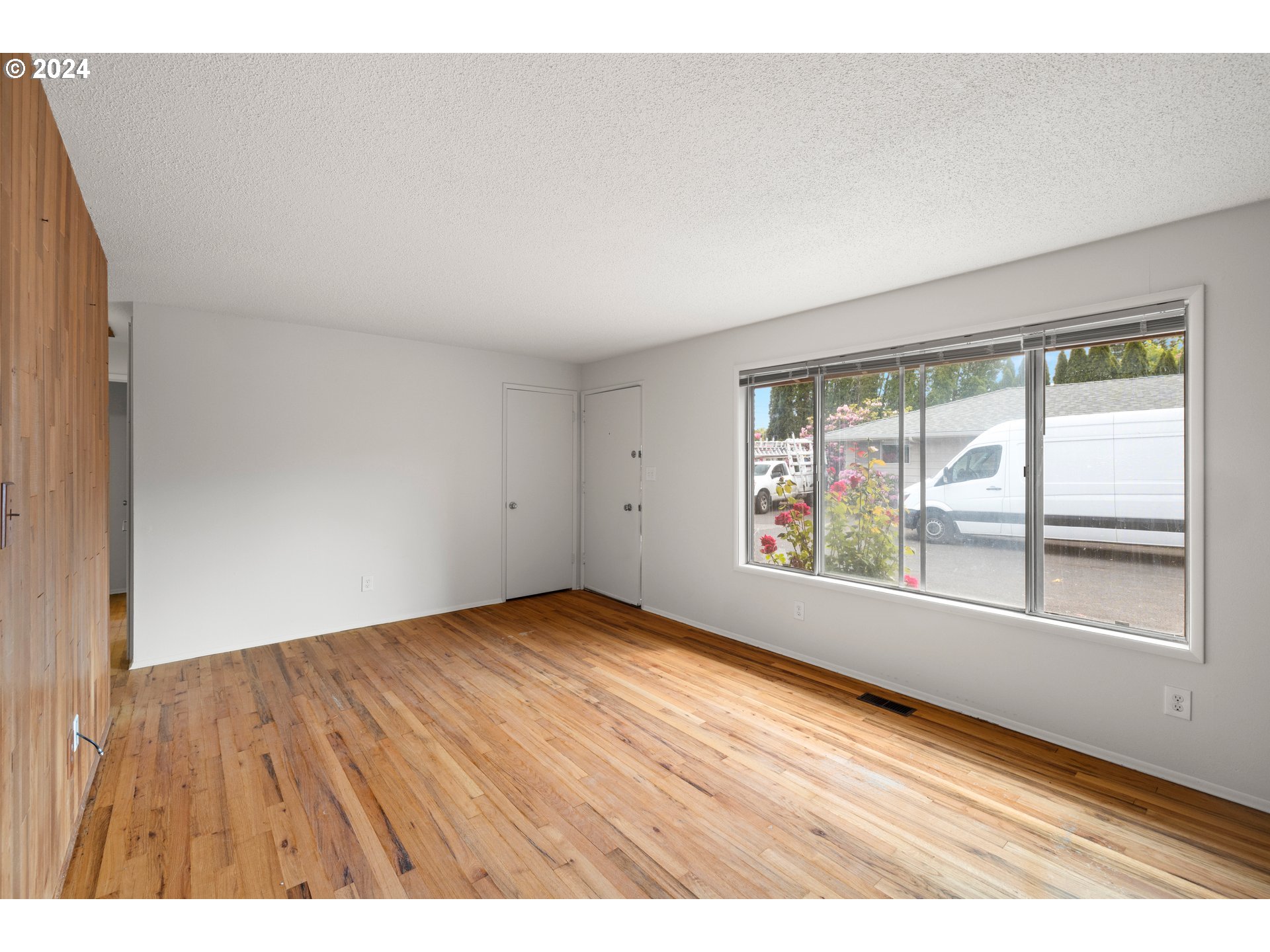 11700 Southwest Denney Road Beaverton, OR 97008 - Photo 3 of 23 an empty room with wooden floor and windows