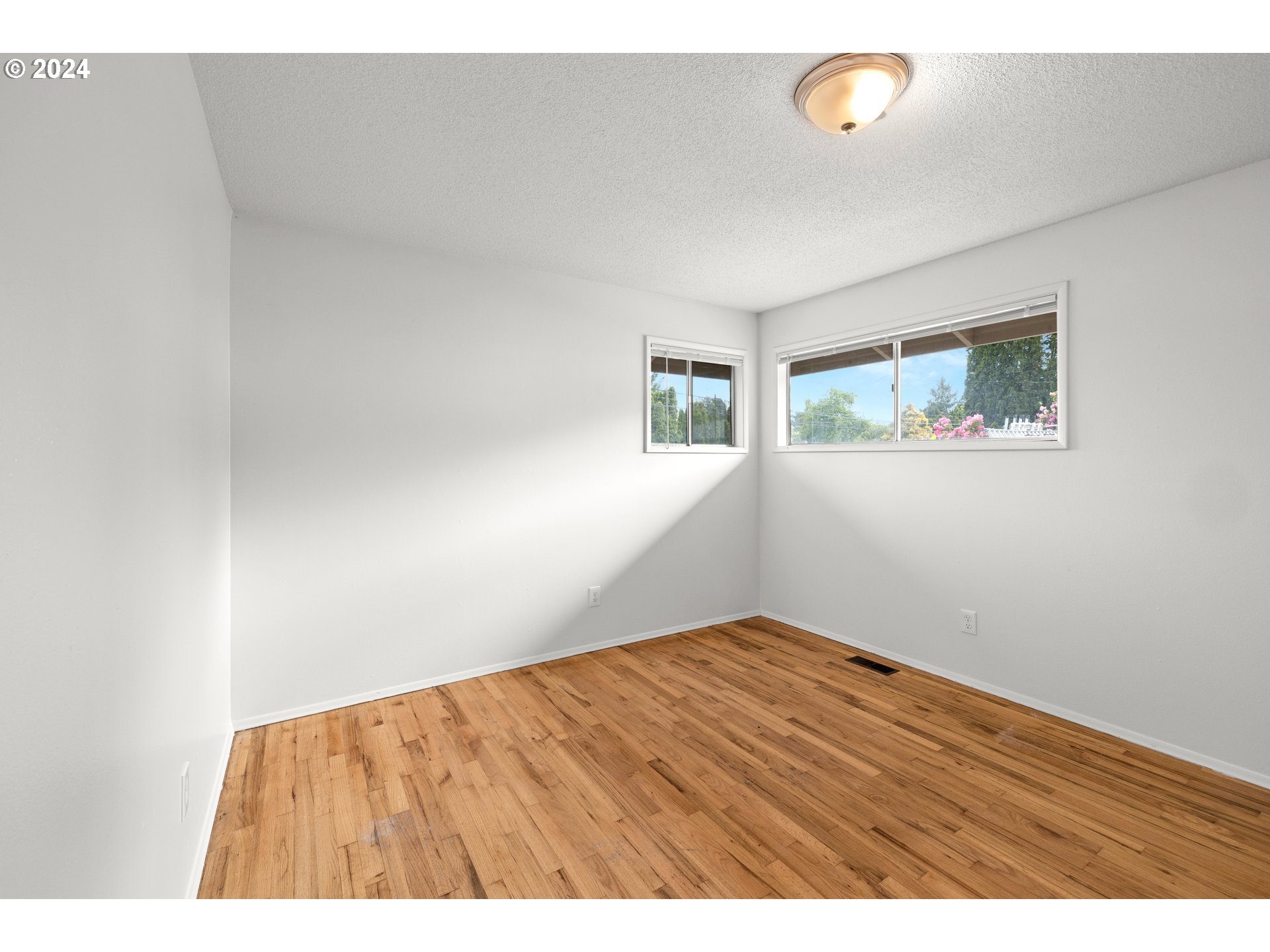 11700 Southwest Denney Road Beaverton, OR 97008 - Photo 9 of 23 a view of an empty room with wooden floor
