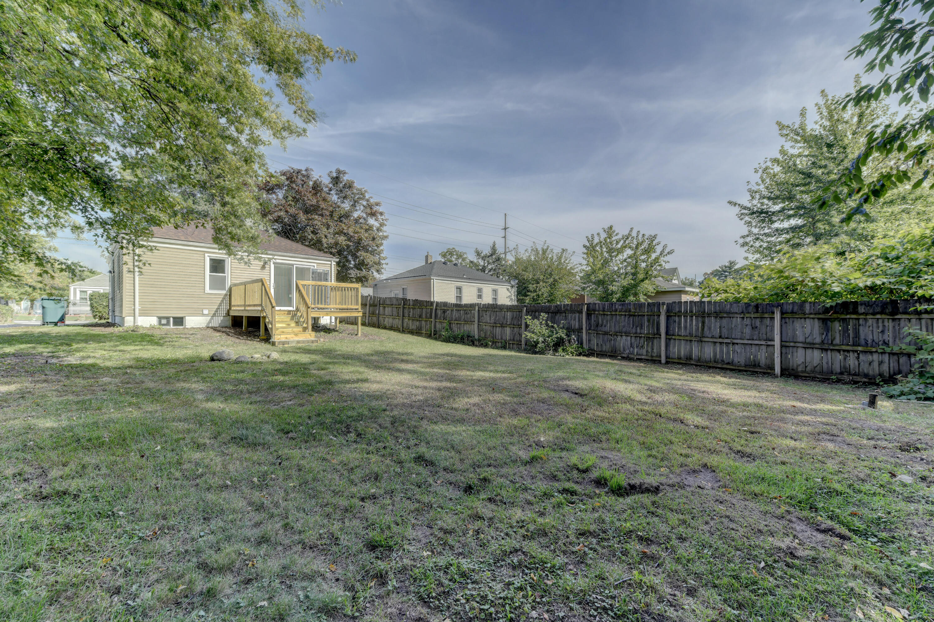 824 Elm Street Valparaiso, IN 46383 - Photo 19 of 20 a view of a backyard with large trees and wooden fence
