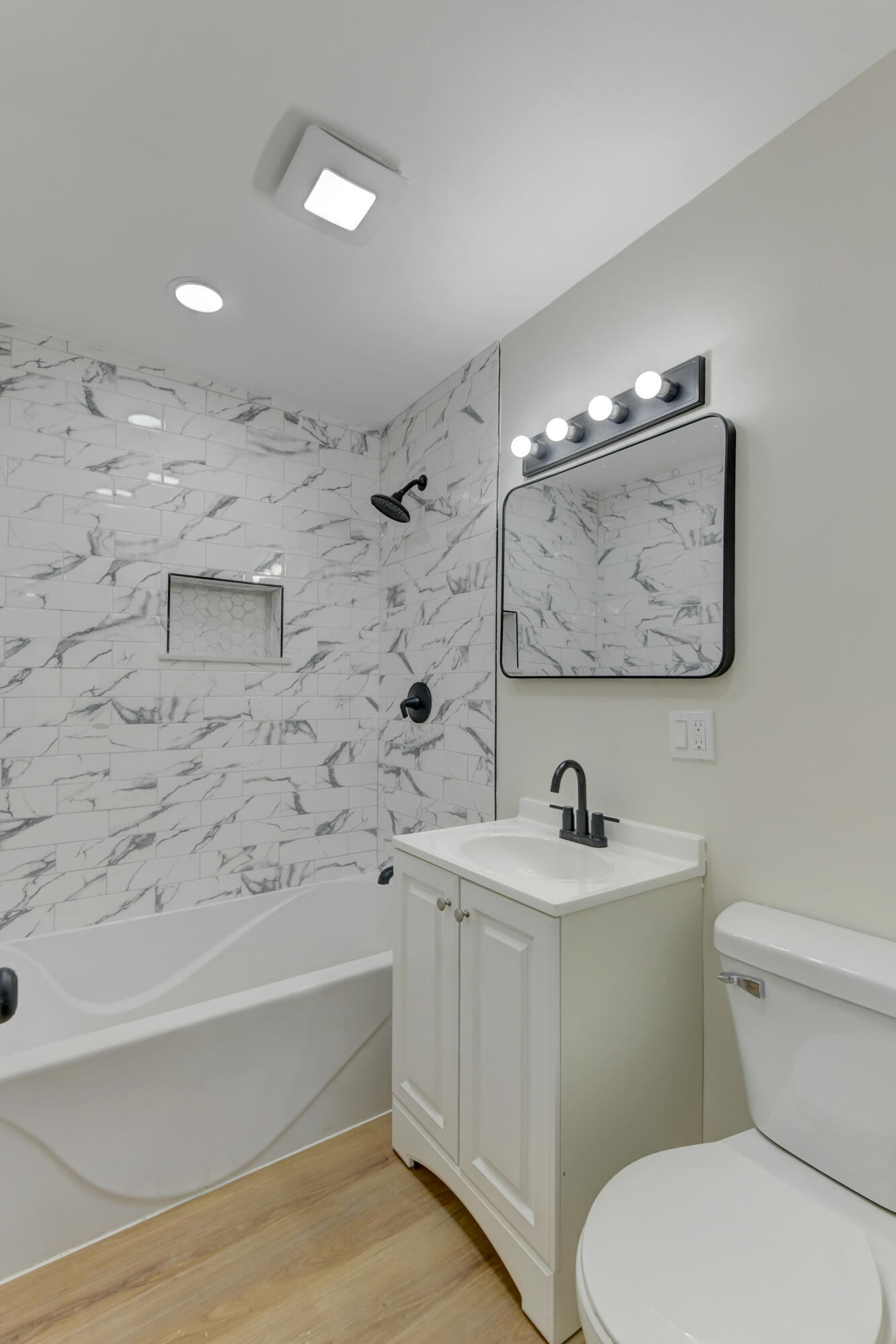 824 Elm Street Valparaiso, IN 46383 - Photo 9 of 20 a bathroom with a sink mirror toilet and bathtub