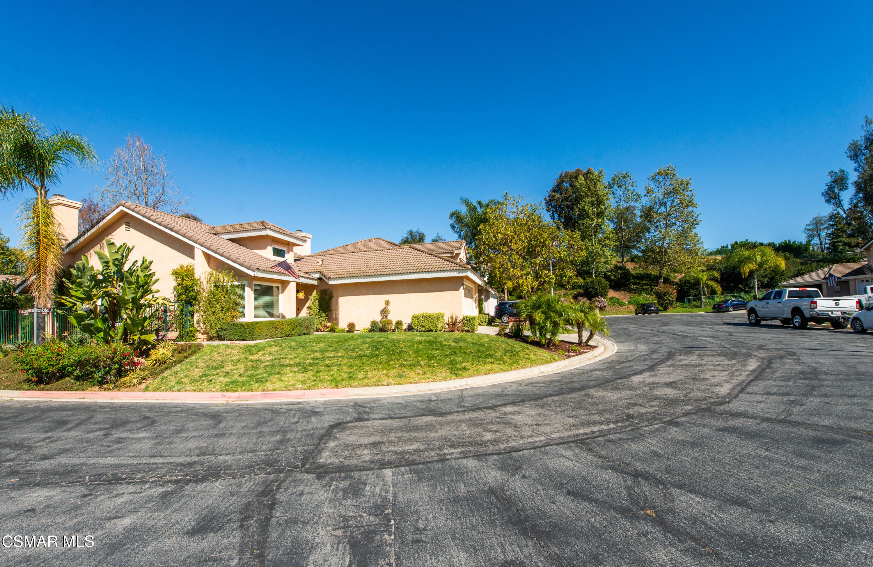 65 Iron Ridge Lane Simi Valley, CA 93065 - Photo 2 of 33 a front view of a house with a garden and trees