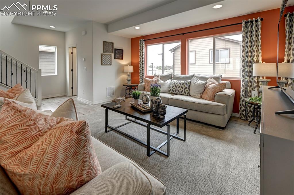 4456 Samaritan Loop Colorado Springs, CO 80916 - Photo 13 of 25 a living room with furniture and a large window