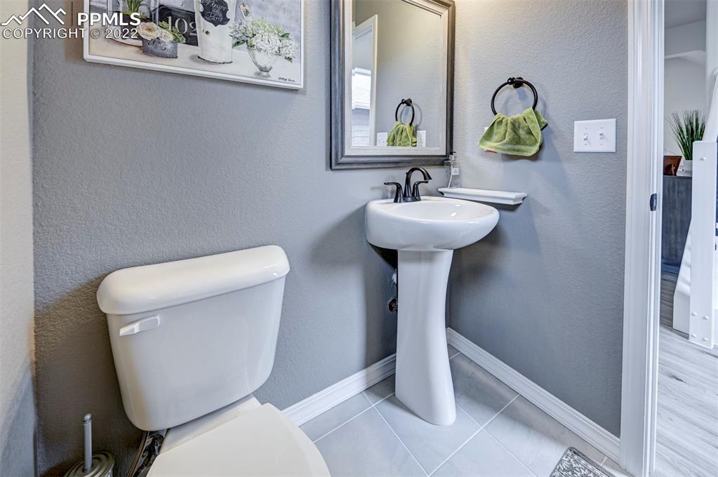 4456 Samaritan Loop Colorado Springs, CO 80916 - Photo 19 of 25 a bathroom with a toilet sink and mirror