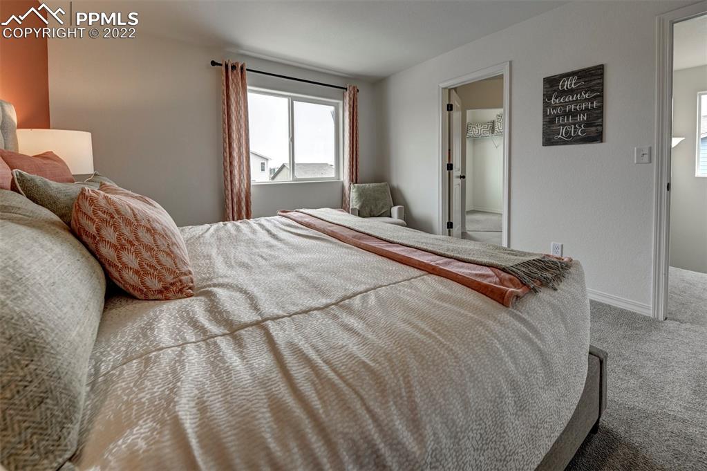 4456 Samaritan Loop Colorado Springs, CO 80916 - Photo 21 of 25 a bedroom with a bed and a window