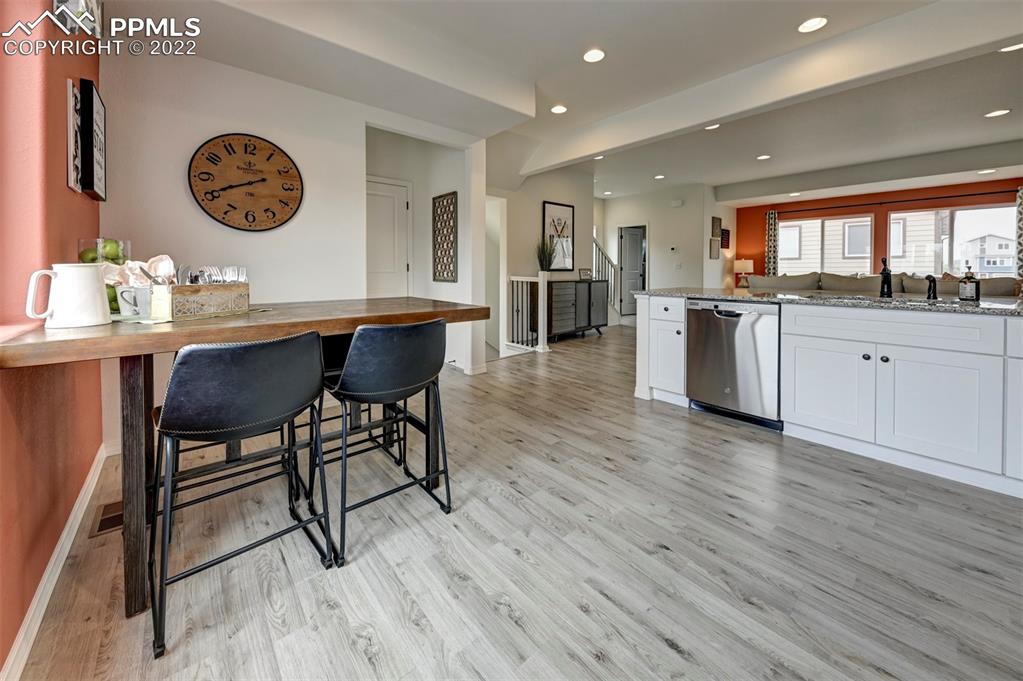 4456 Samaritan Loop Colorado Springs, CO 80916 - Photo 5 of 25 a view of kitchen with granite countertop counter top space and wooden floor