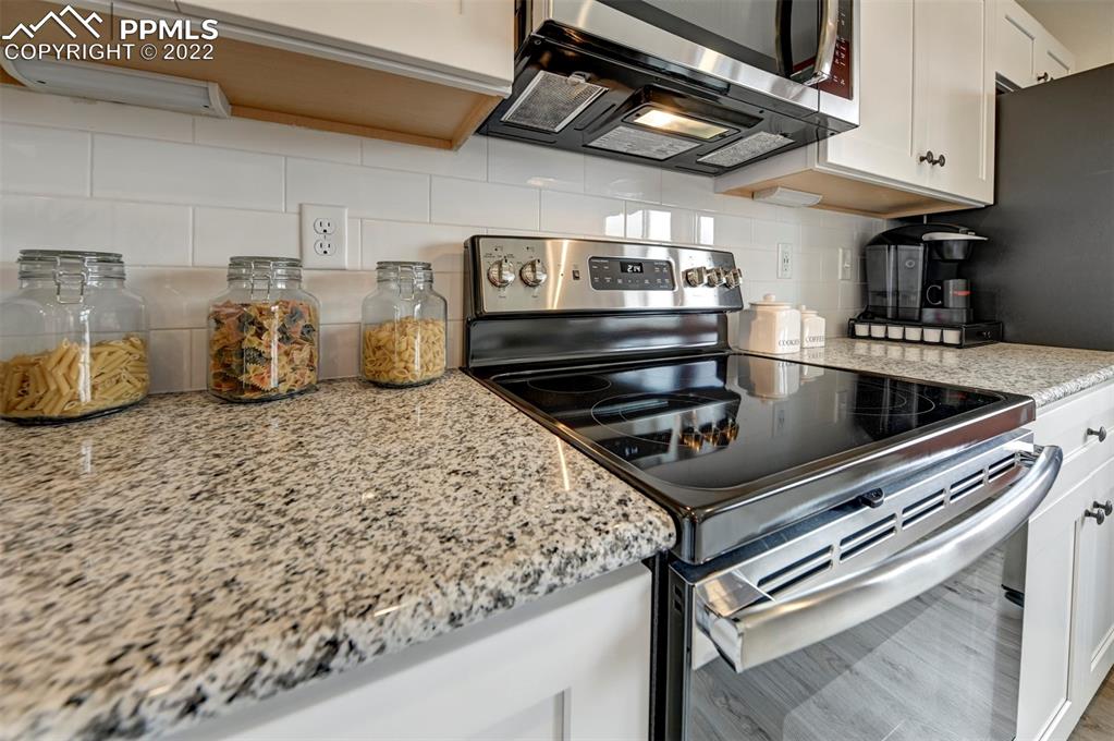 4456 Samaritan Loop Colorado Springs, CO 80916 - Photo 7 of 25 a kitchen with a stove and a sink