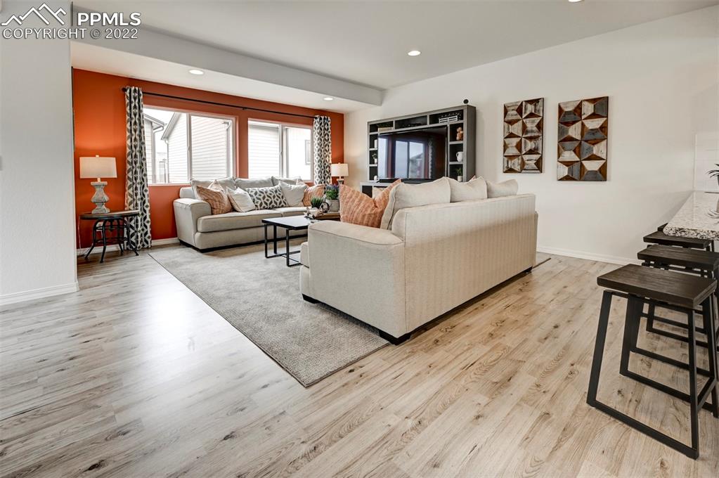 4456 Samaritan Loop Colorado Springs, CO 80916 - Photo 10 of 25 a living room with furniture and a wooden floor