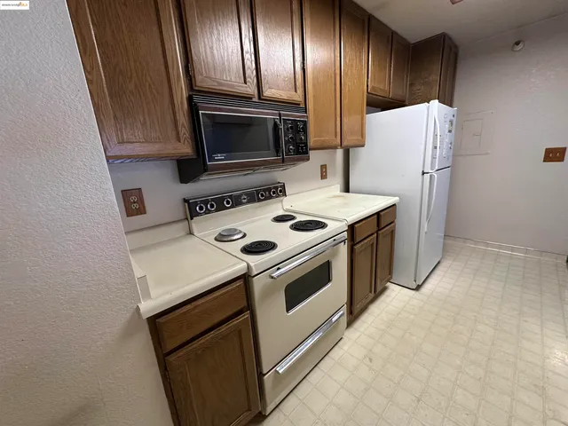 a kitchen with a stove microwave and refrigerator
