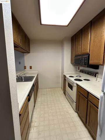 a kitchen with a stove sink and a microwave