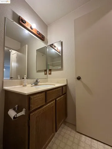 a bathroom with a double vanity sink and a mirror