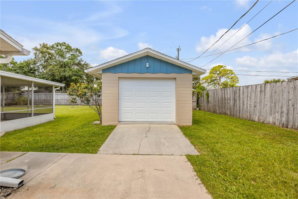 2416 Pine Tree Drive Edgewater, FL 32141 - Photo 13 of 50 a front view of a house with garden