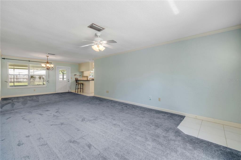 2416 Pine Tree Drive Edgewater, FL 32141 - Photo 16 of 50 wooden floor in an empty room with a window