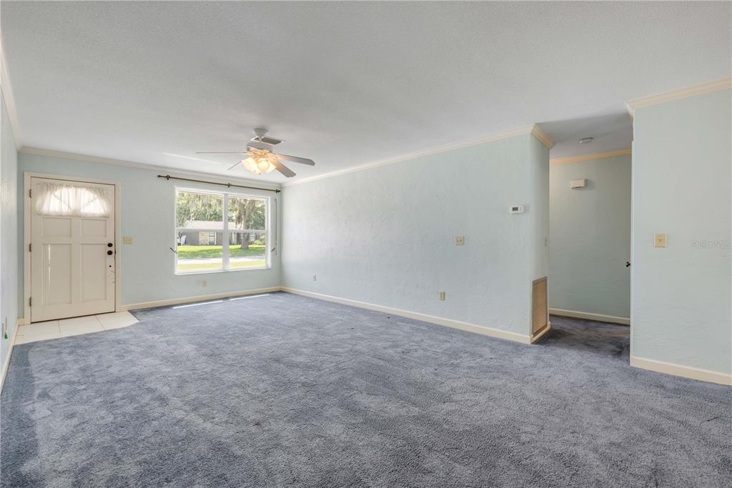 2416 Pine Tree Drive Edgewater, FL 32141 - Photo 18 of 50 an empty room with windows and closet