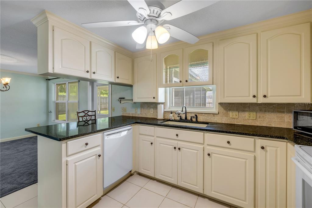 2416 Pine Tree Drive Edgewater, FL 32141 - Photo 27 of 50 a kitchen with white cabinets and sink