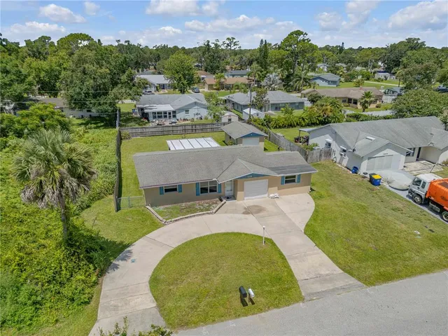 an aerial view of a house with a swimming pool