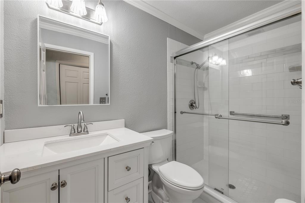 2416 Pine Tree Drive Edgewater, FL 32141 - Photo 31 of 50 a bathroom with a sink a toilet and shower