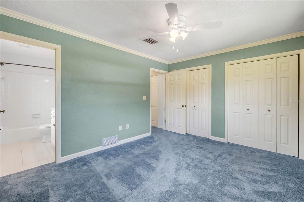 2416 Pine Tree Drive Edgewater, FL 32141 - Photo 33 of 50 a view of an empty room with a ceiling fan