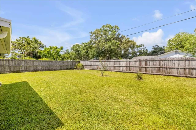 a view of a swimming pool with a yard