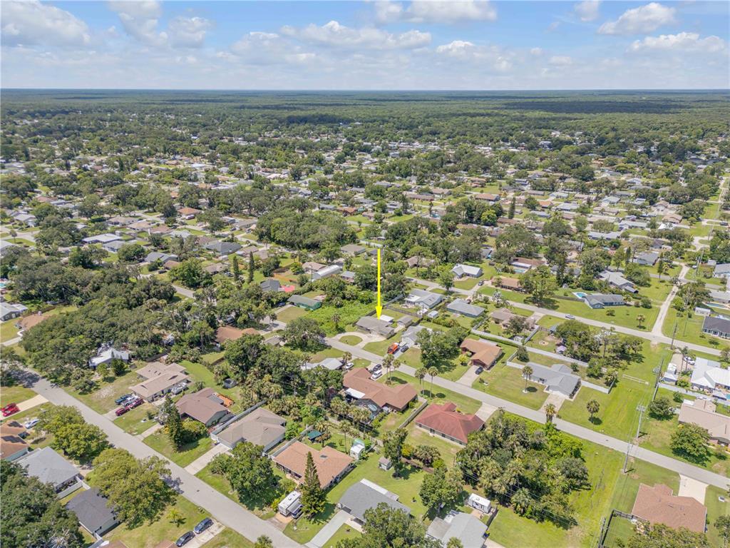 2416 Pine Tree Drive Edgewater, FL 32141 - Photo 50 of 50 an aerial view of residential houses with outdoor space and trees