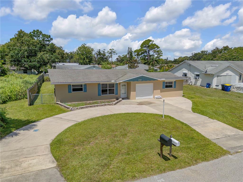 2416 Pine Tree Drive Edgewater, FL 32141 - Photo 5 of 50 a view of a house with a swimming pool