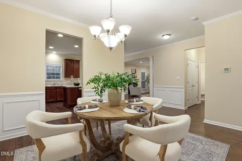 a kitchen with stainless steel appliances granite countertop a refrigerator a sink dishwasher a stove and a oven with wooden floor
