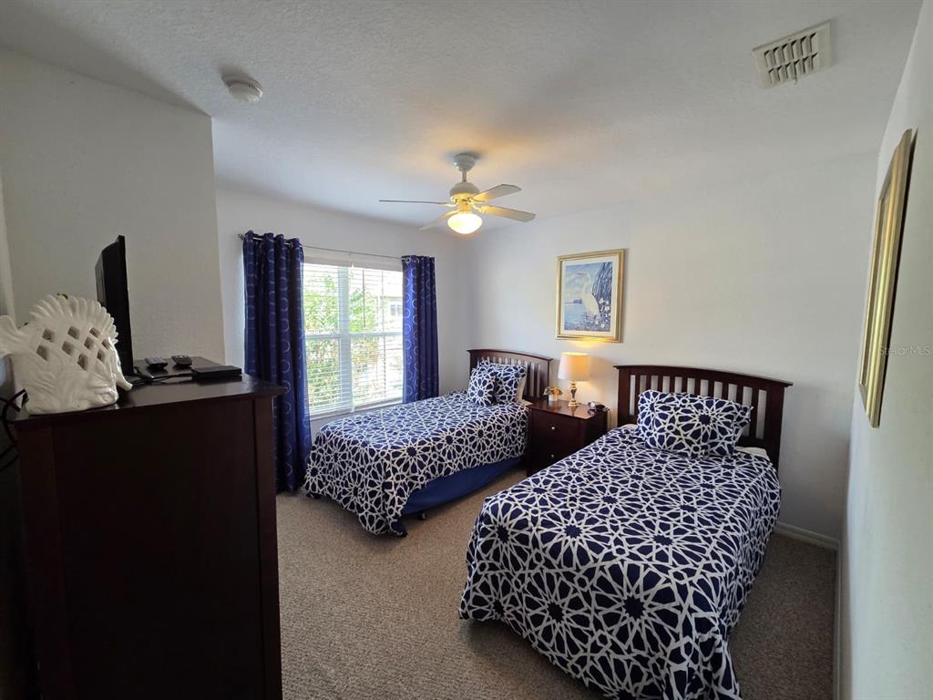 4600 Yellowgold Road West, Unit 106 Kissimmee, FL 34746 - Photo 11 of 25 a bedroom with two beds and a window