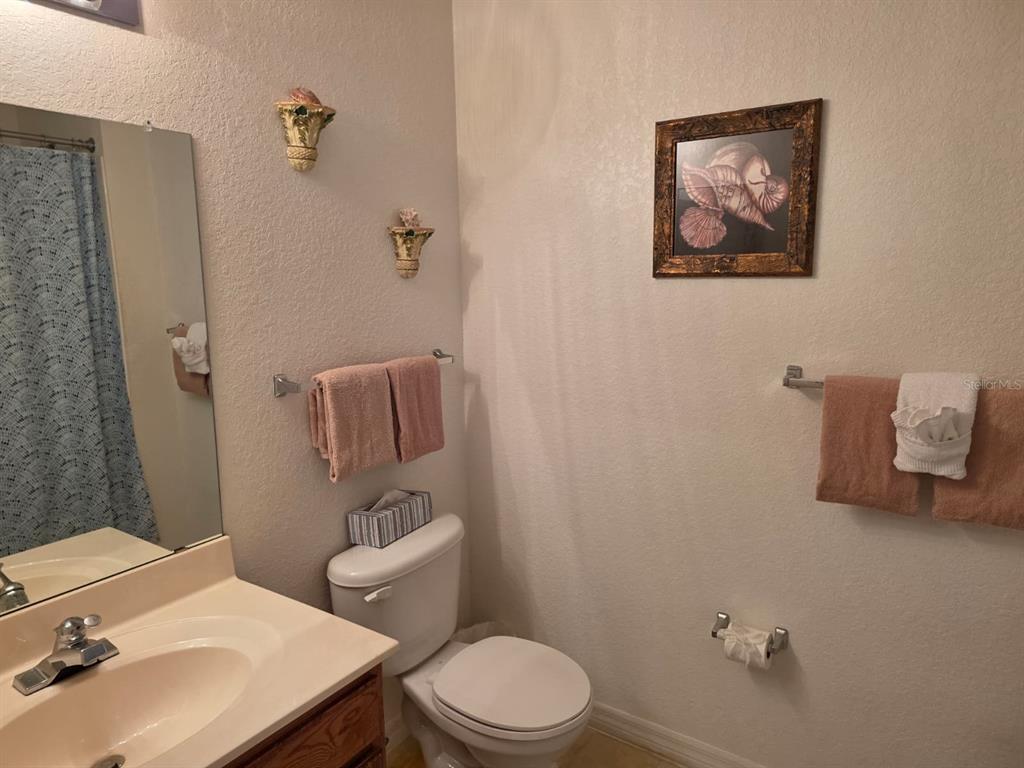 4600 Yellowgold Road West, Unit 106 Kissimmee, FL 34746 - Photo 13 of 25 a bathroom with a sink mirror and toilet