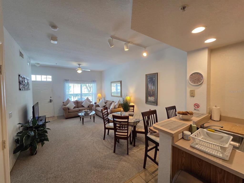 4600 Yellowgold Road West, Unit 106 Kissimmee, FL 34746 - Photo 5 of 25 a living room with lots of furniture and a large window