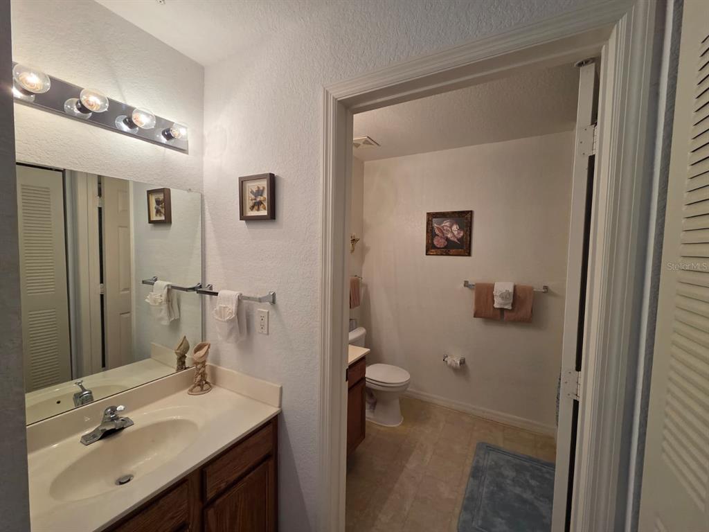 4600 Yellowgold Road West, Unit 106 Kissimmee, FL 34746 - Photo 9 of 25 a bathroom with a sink a toilet and shower