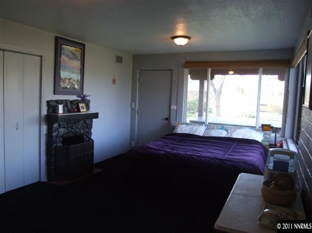 15165 Kivett Lane Reno, NV 89521 - Photo 8 of 12 a bed sitting in a bedroom next to a window