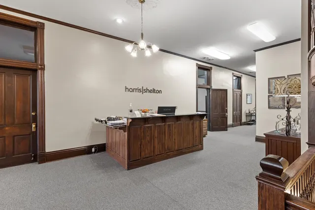 a living room with furniture a chandelier and a flat screen tv